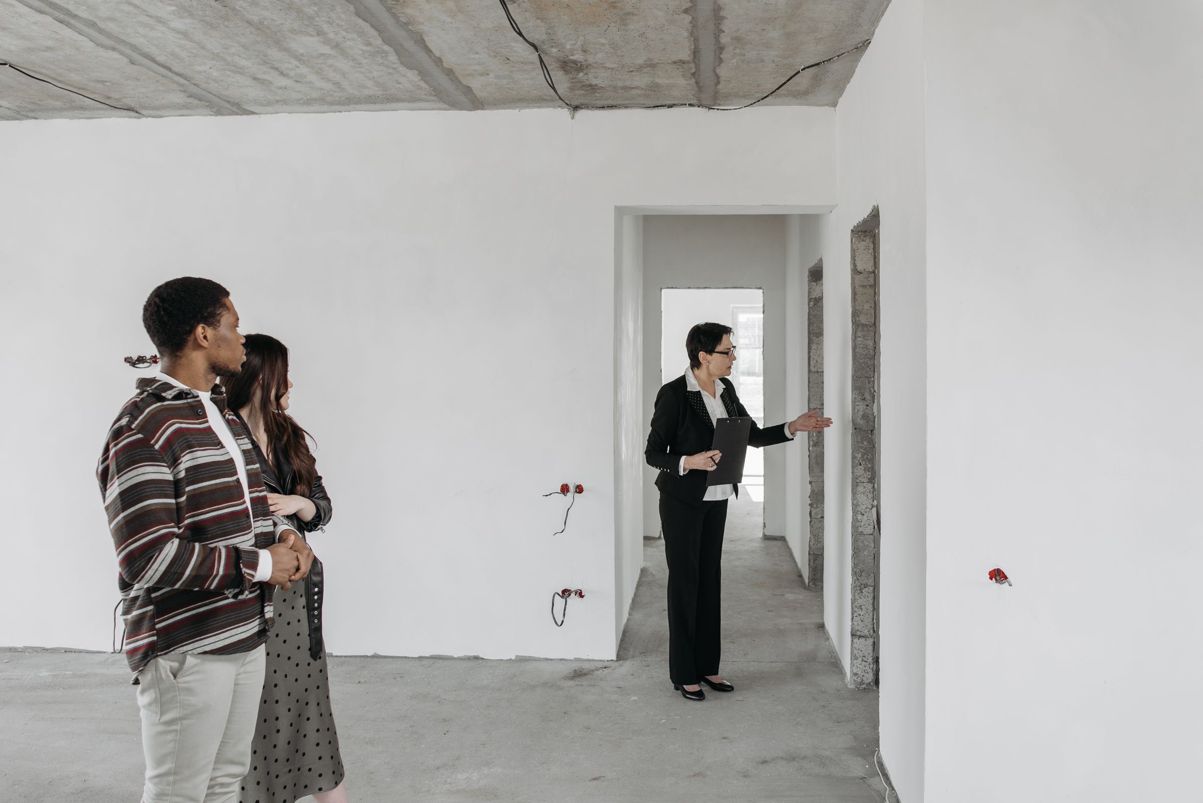 A couple with a real estate agent inspecting a property